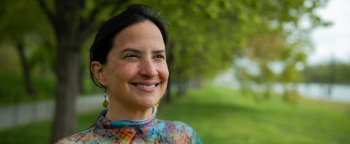 Josefina Braña Varela standing in a grassy park beneath a canopy of trees.