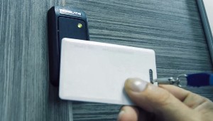 A white card being used to unlock a door
