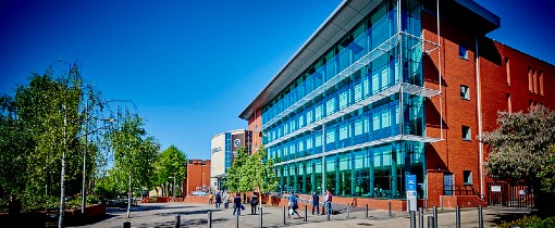 Exterior of the MD Ambika Paul building, students walking around outside it