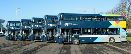 A parked line of five blue double decker buses with University of Wolverhampton branding