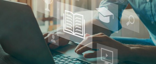 Image of a laptop computer being operated by a pair of hands from outside the frame.