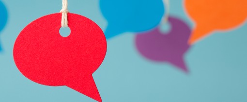 Image of variably coloured speech bubbles hung from strings.
