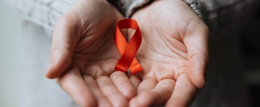 Hands holding a red ribbon