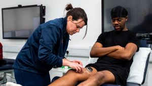 Lecturer doing test on student