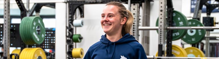 Female sport student smiling and using facilities