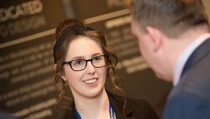 Colleagues talking in front of camera