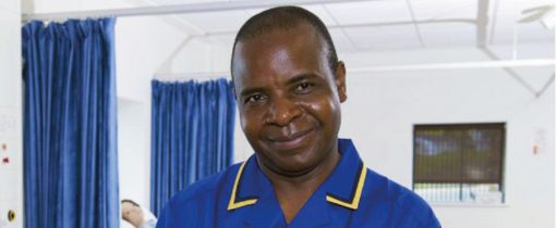 Alumni Moses smiling at camera