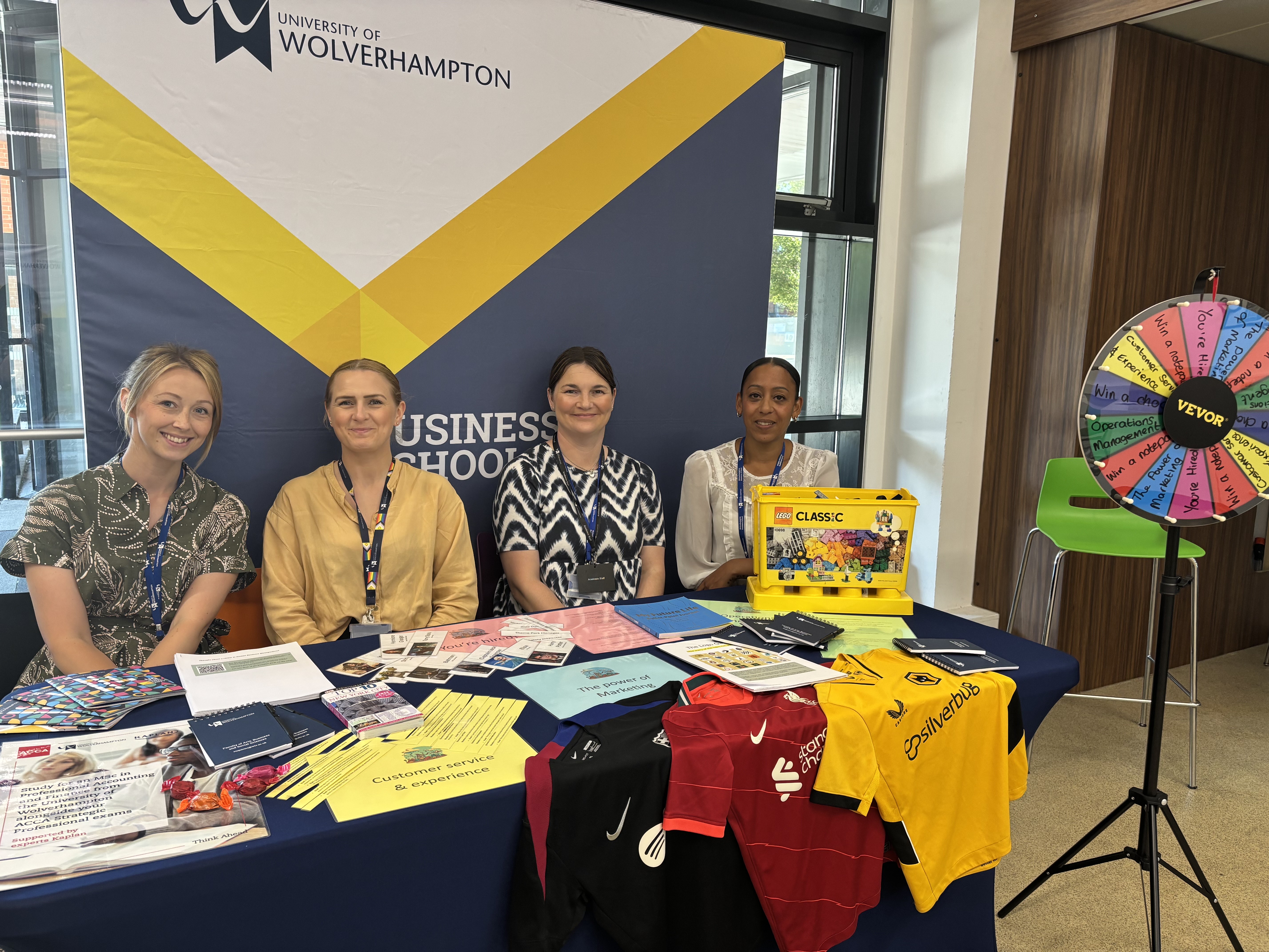 the business school stand with staff at open day