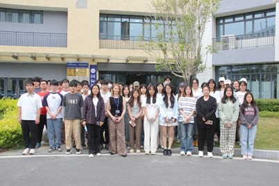 a female lecturer stands infront of a class in china