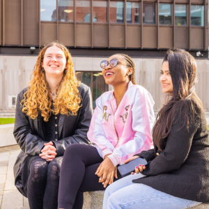 three students laughing outside
