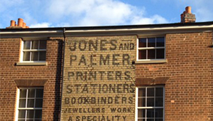 Brick building emblazoned with JONES AND PAEMER printers branding