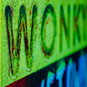 Image of a green rectangular sign with the word WONKY embossed into it.