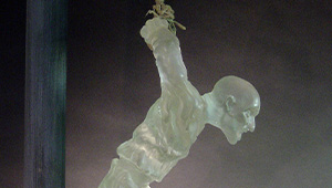 Depiction of a man hanging from his wrists, the body created with translucent material