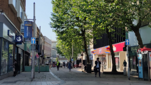 Wolverhampton city centre high street with many storefronts at the sides of the walking path