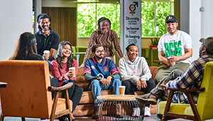Students sitting in relaxed student area chatting and drinking hot drinks.