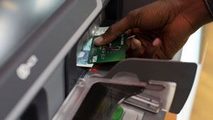 300 x 170 image of someone using a cashpoint machine