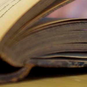 An old hardback book open on a table.