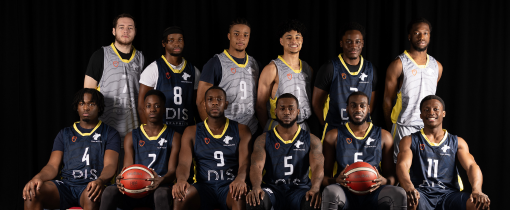 Photograph of the University of Wolverhampton men basketball team for 2023-24, posed together wearing matching blue or grey uniforms with yellow details.
