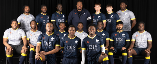 Photograph of the University of Wolverhampton men football team for 2023-24, posed together wearing matching blue or grey uniforms with yellow details.