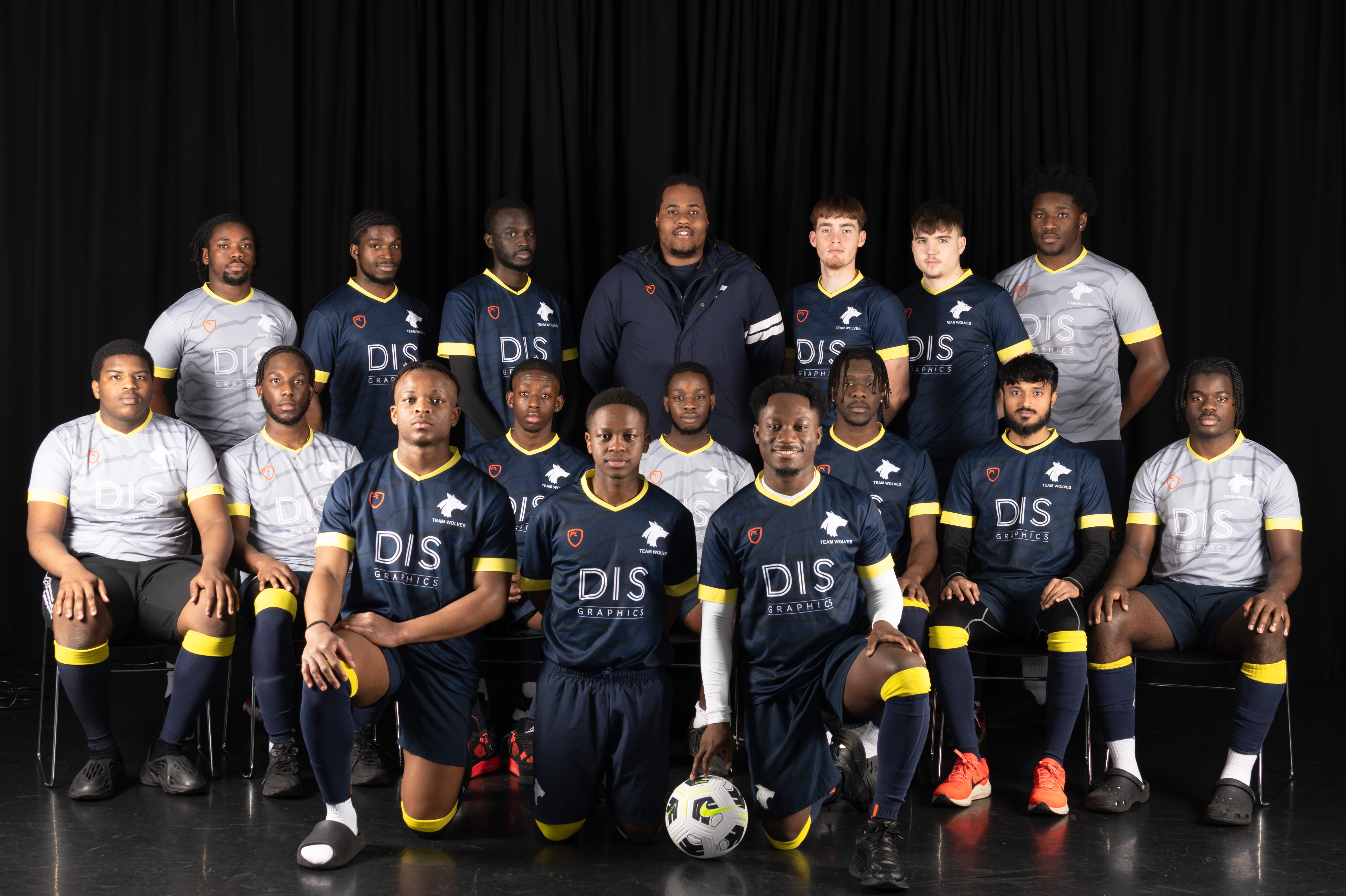 Photograph of the University of Wolverhampton men football team for 2023-24, posed together wearing matching blue or grey uniforms with yellow details.